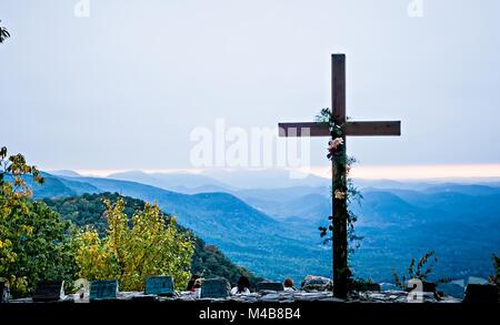 Il culto cristiano croce che affaccia sulle montagne di sunrise Foto Stock