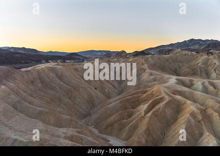 Alba sul famoso mudstone e argillose di Zabriskie Point, Parco Nazionale della Valle della Morte, California. Foto Stock