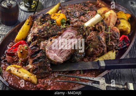 Articolazioni di agnello con patate fritte in salsa di Borgogna sulla piastra Foto Stock