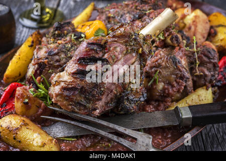 Articolazioni di agnello con patate fritte in salsa di Borgogna sulla piastra Foto Stock