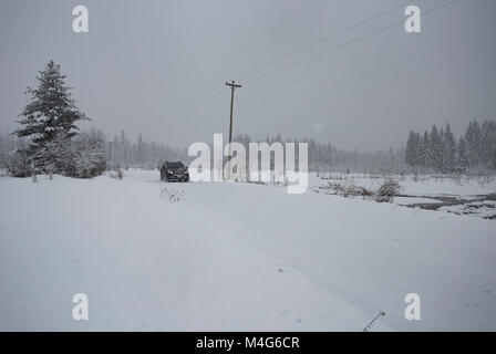 Sanders County, Montana, USA. Xvi Feb, 2018. 16/02/2018 Snow evento. Tempesta di neve. Un SUV la guida nella neve sulla forcella del sud di Bull River Road, vicino all'incrocio dell'autostrada 56, Bull Lake Road, nella contea di Sanders, Montana. La strada si trova in una sezione di distributori del Cabinet montagne, circa 20 miglia a nord di Noxon, Montana. La zona è colpita con neve pesante, proveniente dall'occidente. La tempesta dovrebbe durare diversi giorni. Credito: Martin Fotografia Battilana - Alamy/Alamy Live News Foto Stock