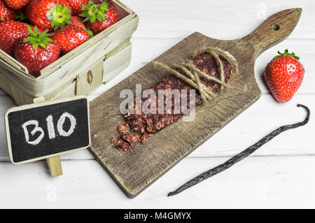 Bio senza glutine proteina bar con ingredienti e copyspace segno su un tavolo di legno. Foto Stock