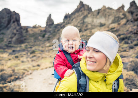 Madre con bambino viaggia nello zaino. Avventura Trekking con bambino in autunno viaggio con la famiglia in montagna. Vacanze Viaggio con bambino portato o Foto Stock