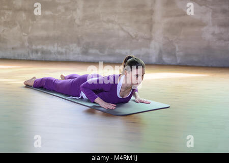 Bella athletic giovani femmine fare yoga asana bassa cobra. Foto Stock