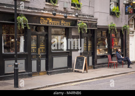 Uomo di bere al di fuori delle sette stelle pub, Carey Street, Holborn, città di Londra, Regno Unito Foto Stock