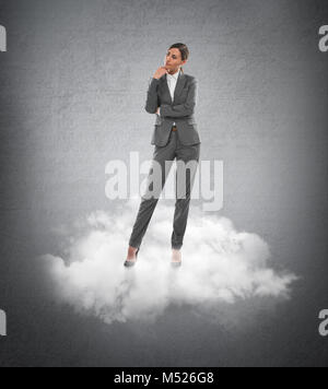 Azienda giovane donna in piedi su una nuvola Foto Stock
