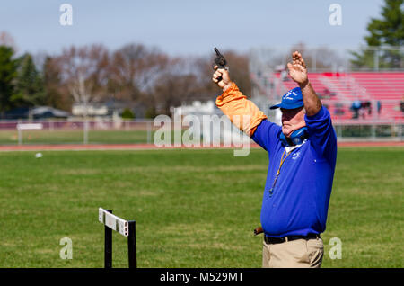 Ufficiale di gara pistola spara per avviare la via e il campo gara in Albany, NY.ri Foto Stock