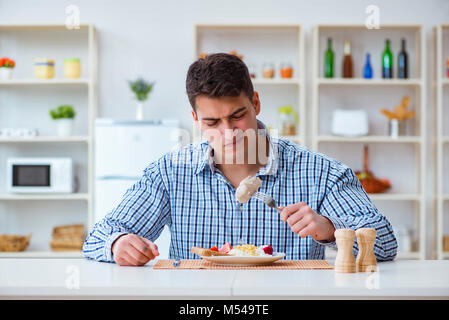 L'uomo mangiare cibo insipido a casa per il pranzo Foto stock - Alamy