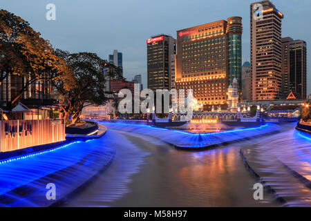 Kuala Lumpur in Malesia: Gennaio 25, 2018: edifici per uffici e Palazzo Sultano Abdul Samad Jamek moschea con fontana illuminata di notte sulle rive del Kl Foto Stock