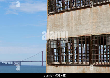 La formazione di ruggine di barre di nuove industrie edificio su Alcatraz, il Golden Gate Bridge in background. Foto Stock