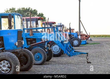Russia, Temryuk - 15 Luglio 2015: trattore, in piedi in una fila. Macchine agricole. Il parcheggio delle macchine agricole Foto Stock