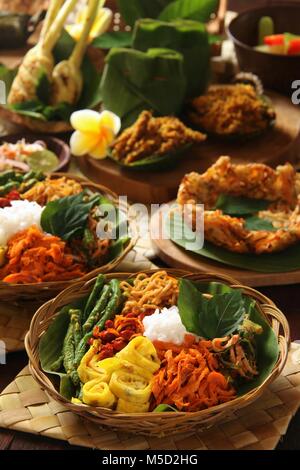 Il Nasi Campur Bali. Popolare Balinese tradizionale piatto di riso al vapore serviti con vari contorni. Foto Stock