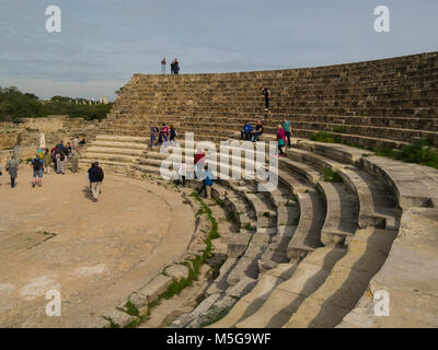 I turisti in seduta su alcune delle righe di 50 posti a sedere 15000 spettatori nelle rovine di teatro a Salamina Famagusta Repubblica Turca di Cipro del Nord Foto Stock