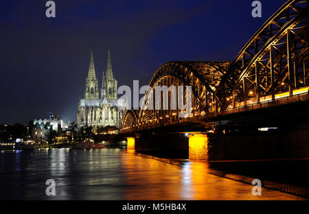 Germania. Colonia. Vista notturna del ponte di Hohenzollern sul fiume Reno. Sullo sfondo la Cattedrale. Regione della Renania settentrionale-Vestfalia. Foto Stock