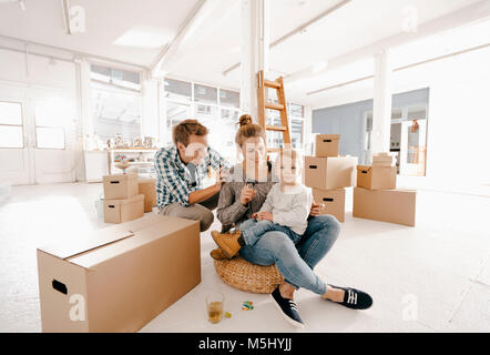 La famiglia felice in movimento nella nuova casa Foto Stock