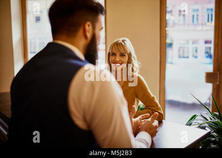 Eleganti Donna sorridente all uomo in un bar Foto Stock