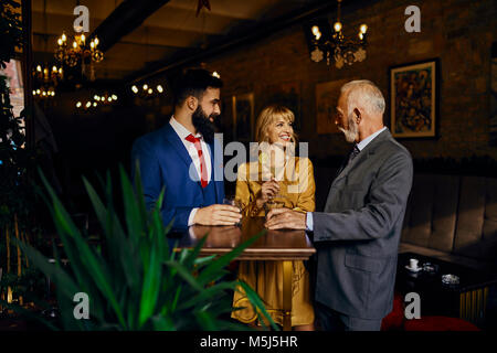 Due eleganti uomo e donna socializzare in un bar Foto Stock