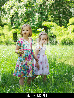 Adorabili bambine (suore) nel giardino estivo. Foto Stock