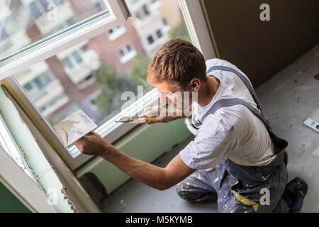 Stuccatore ristrutturando interni di pareti e soffitti. Foto Stock