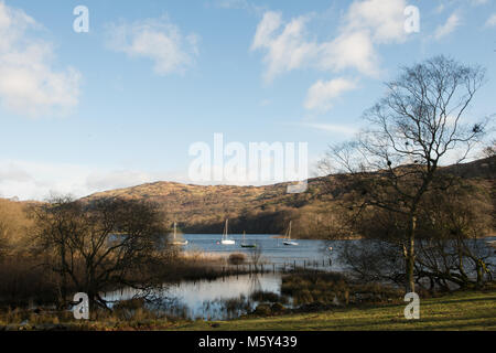 Coniston Water dal lago di Banca con alcuni ormeggiate barche a vela seduta nella baia. Foto Stock