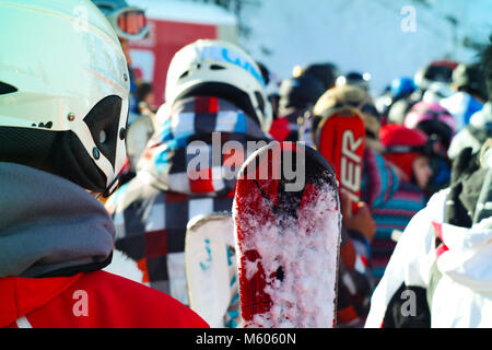 Sport invernali: gruppo di persone con gli sci e gli snowboard in attesa in linea Foto Stock