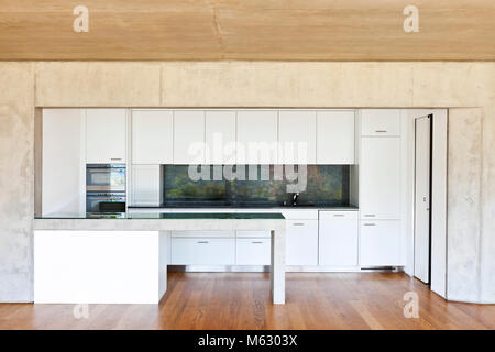 Moderna casa di calcestruzzo con pavimento in legno, cucina Foto Stock