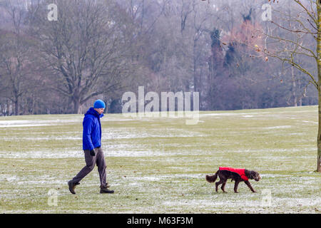 Northampton, Inghilterra. 28 Feb, 2108. Regno Unito: Meteo Temperature a -2 questa mattina con una leggera spolverata di neve per la gente a piedi i loro cani in Abington parco avvolto fino contro la terribilmente freddo brezza. Credito: Keith J Smith./Alamy Live News Foto Stock