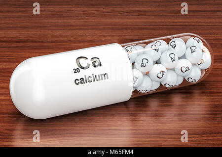 Capsula con calcio Ca elemento sul tavolo di legno. Il rendering 3D Foto Stock