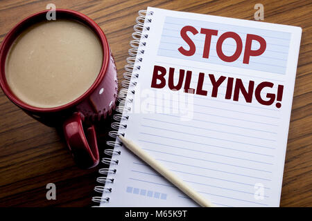 La scrittura a mano didascalia di testo ispirazione mostra arrestare il bullismo. Il concetto di business per la prevenzione problema Bully scritta sulla nota blocco di carta sul legno Foto Stock