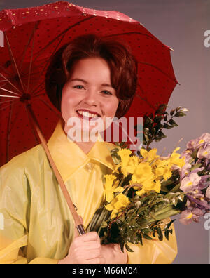 Anni sessanta sorridente BRUNETTE donna che indossa un impermeabile giallo AZIENDA FIORI E Ombrellone rosso guardando telecamera - kf4211 HAR001 HARS IMPERMEABILE STUDIO SHOT salubrità cresciuto una sola persona la natura spazio copia di metà lunghezza LADIES RAINY CRESCIUTI NOSTALGIA il contatto visivo 20-25 anni 25-30 anni BRUNETTE FELICITÀ DAFFODILS allegro sorriso gioioso piccolo gruppo di oggetti IRIS MID-adulto metà donna adulta primavera etnia caucasica guardando la fotocamera in vecchio stile persone Foto Stock