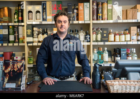 Il manager dell'Harvey's Brewery real ale shop di Lewes, East Sussex. Foto Stock