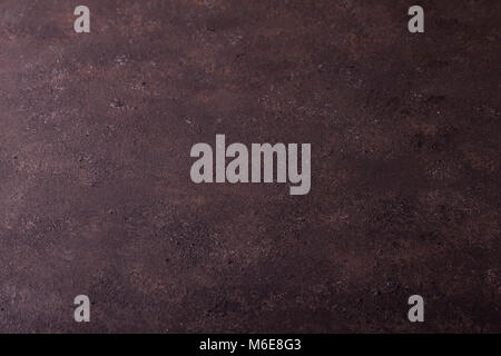 Brufoli texture di superficie di sfondo, calcestruzzo imitazione di ferro arrugginito. porosa della parete piana di colore marrone, brufoli, copia dello spazio. Texture di superficie ruvida Foto Stock