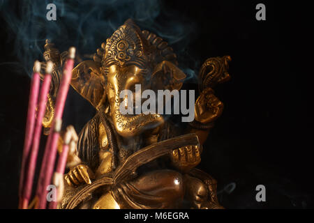 Dio indù Ganesha e fumare bastoncini di incenso Foto Stock