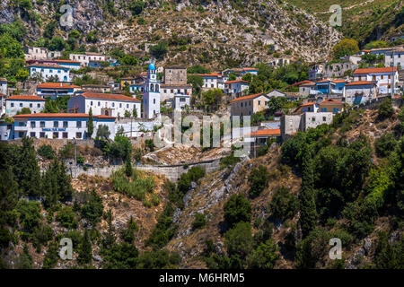 Albanese il villaggio di montagna Dhermi con la chiesa e la scuola edificio ('shkolla' in lingua albanese) Foto Stock