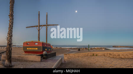 Area giochi sulla spiaggia barca rivolta verso il chiaro di luna all'alba sulla spiaggia della California. Foto Stock