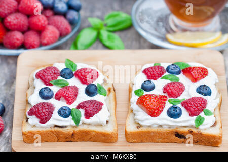 Toast con crema di formaggio e frutti di bosco freschi Foto Stock