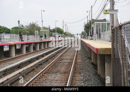 Farmingdale, NY - Giugno 4, 2016: Guardando giù il LIRR tracce come passeggeri pendolari attendere una ferrovia di Long Island in treno a Manhattan, New Foto Stock