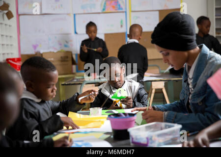 Insegnanti e bambini facendo arti e mestieri in classe Foto Stock