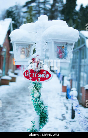 Ritratto di close-up di una coperta di neve di natale decorazione giardino, dichiarando che "Let it snow". Foto Stock