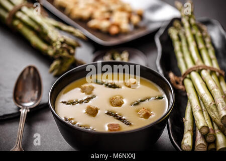 Terrina di asparagi minestra in crema servita con crostoni di pane croccante Foto Stock