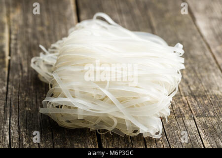 Secchi spaghetti di riso su un tavolo di legno. Foto Stock