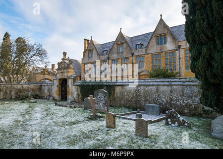 Stanway casa gatehouse e St Peters Churchyard nella neve d'inverno. Stanway, Cotswolds, Worcestershire, Inghilterra Foto Stock