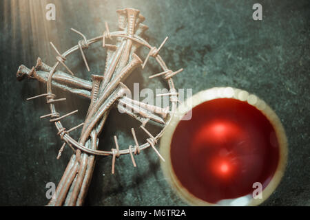 La santa comunione sulla tavola di legno sulla chiesa.tenendo la comunione.Tazza di vetro con il vino rosso, il pane e la Santa Bibbia e croce sul tavolo di legno. Foto Stock
