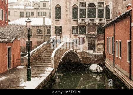 Venezia, Italia - 28 febbraio/1 marzo 2018 una donna attraversa un ponte durante una nevicata a Venezia, Italia. Un soffio di gelo chiamato "Bestia da est" ha afferrato la maggior parte di Europa nel mezzo dell'inverno del 2018, e a Venezia una nevicata ha coperto la città con il bianco, rendendolo affascinante e poetico per cittadini e turisti. © Simone Padovani / risveglio Foto Stock