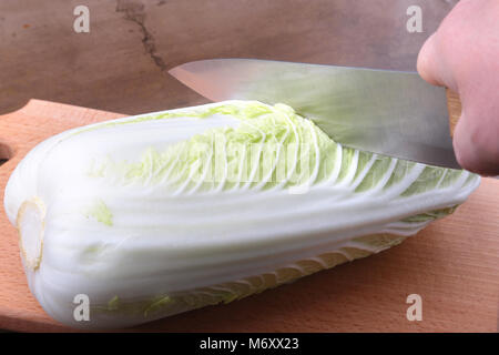 Fresche e mature cavolo cinese e il coltello sul tagliere. Ingredienti per insalata. Pronta per la cottura. Foto Stock