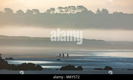 Nebbia di mare e figure pochi cani sulla Plage de KERLOC'H, Crozon Penisola, Finisterre, Bretagne, Francia Foto Stock