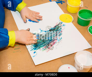 Le mani del Bambino dipinta in vernici colorate. L educazione, la scuola, la creatività e il concetto di pittura. Soft focus un sfocata Foto Stock