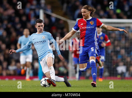 Il Manchester City è Phil Foden (sinistra) e FC Basilea Michael Lang battaglia per la sfera durante la UEFA Champions League round di 16, la seconda gamba corrispondono all'Etihad Stadium e Manchester. Foto Stock