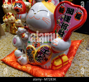 Maneki Neko lucky fortune gatti sul display in un ristorante Foto Stock