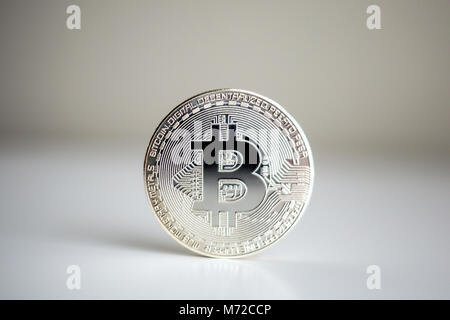 Argento singola moneta bitcoin su bianco bacground in piedi Foto Stock